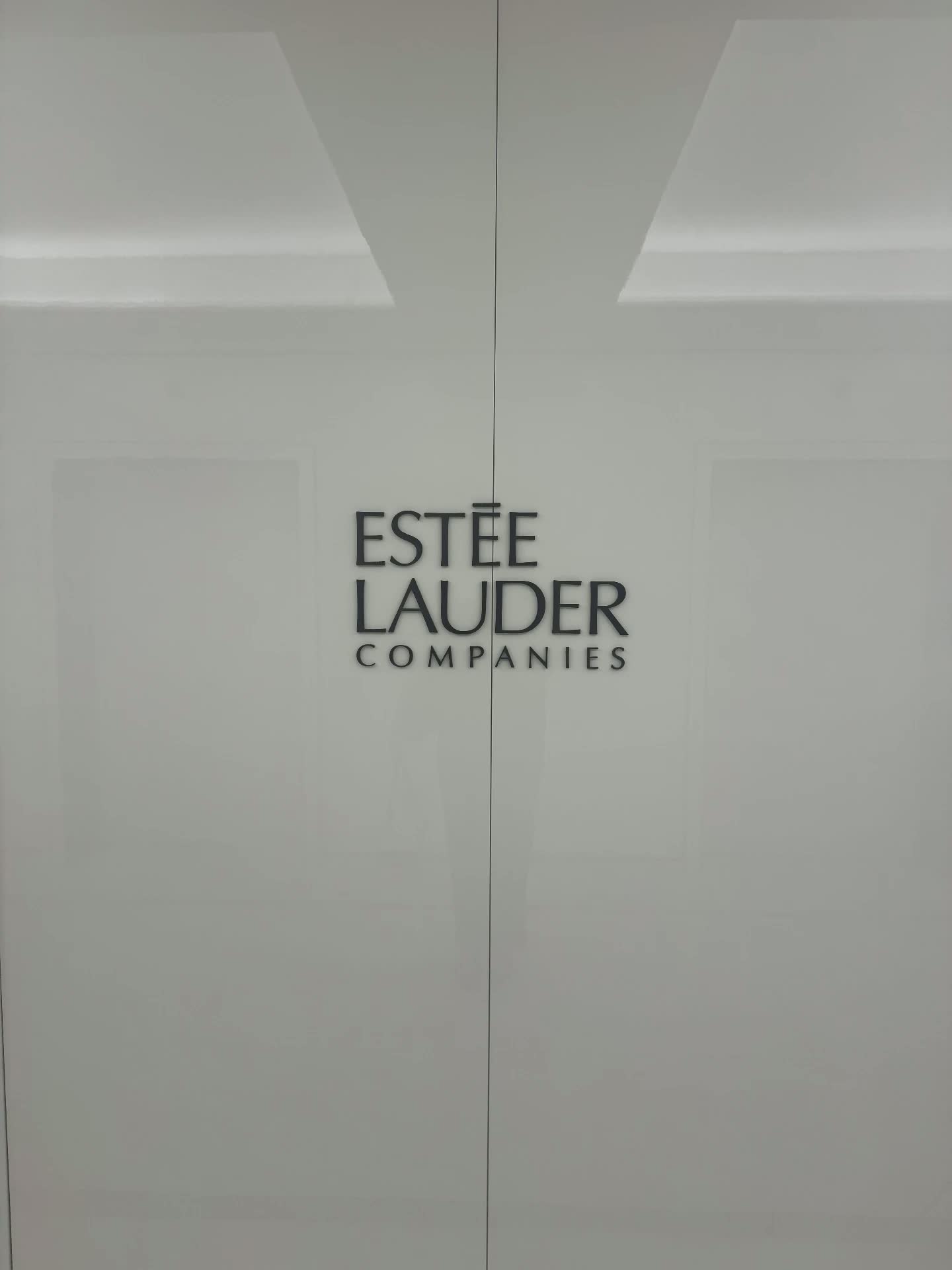 Estée Lauder Companies logo on the office doors